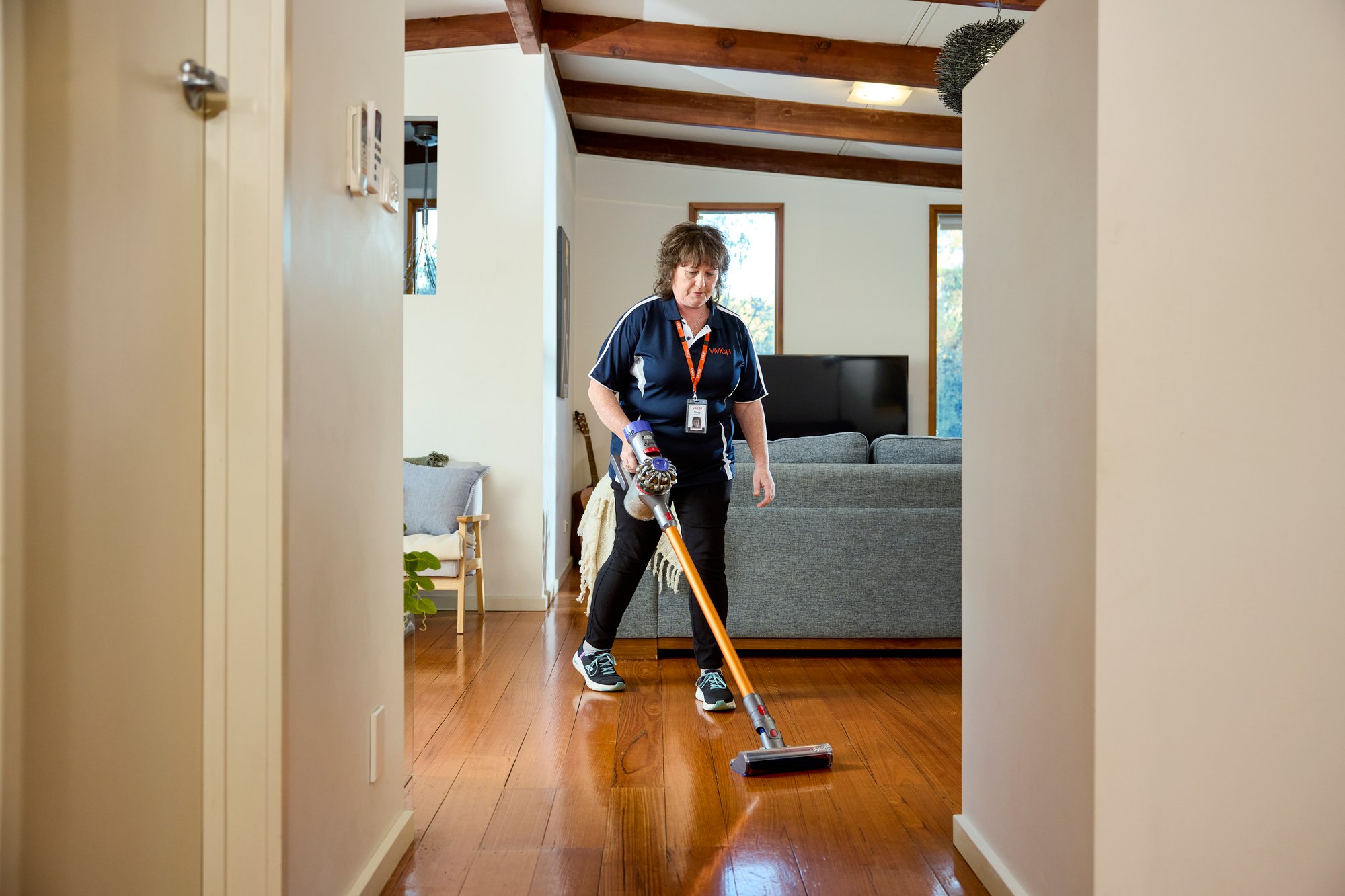 A woman vacuuming.