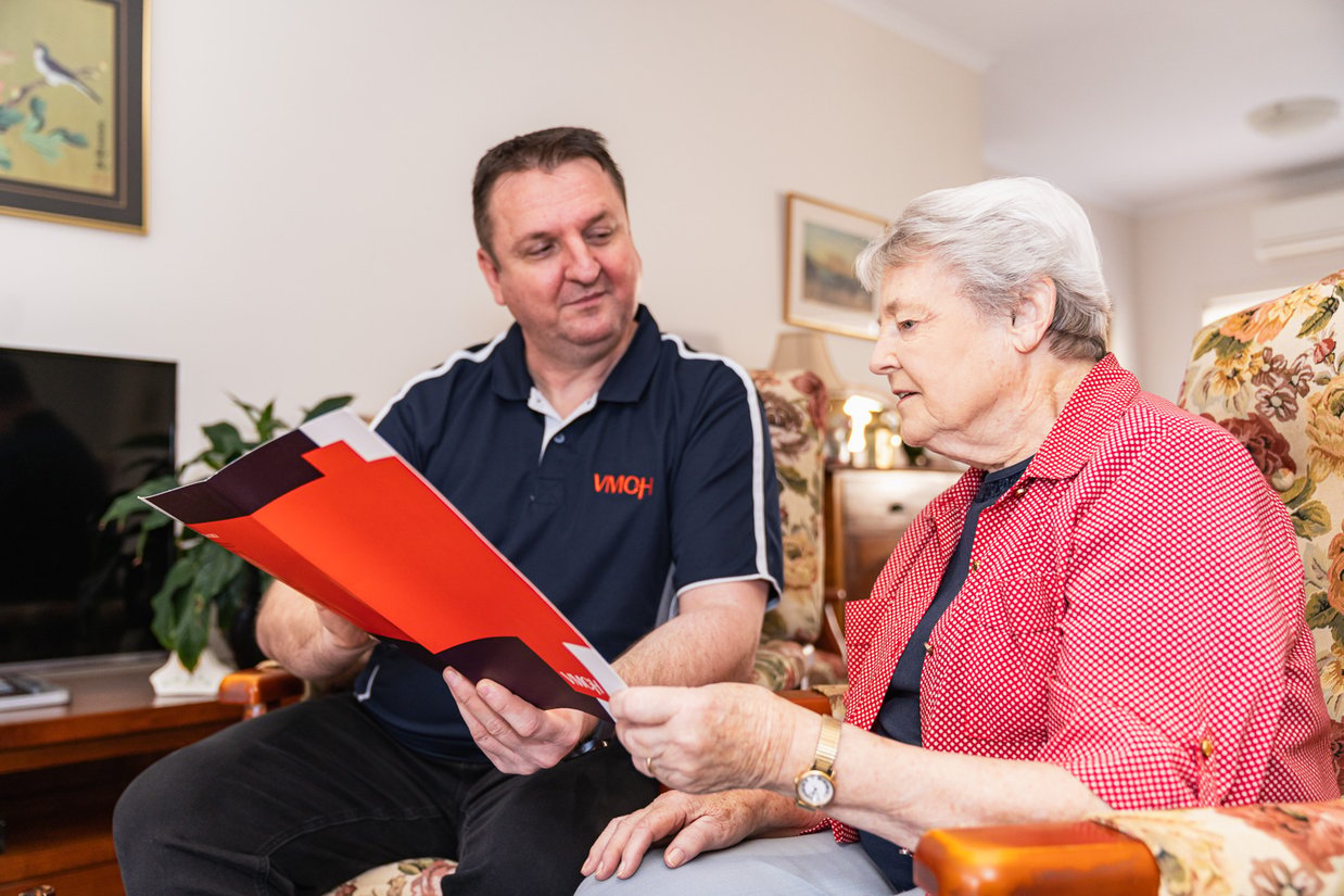 A VMCH care partner explaining funding to a client.