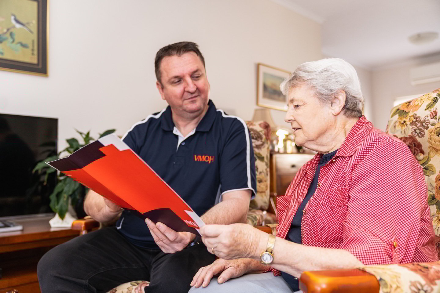 An elderly woman talking to a VMCH worker.