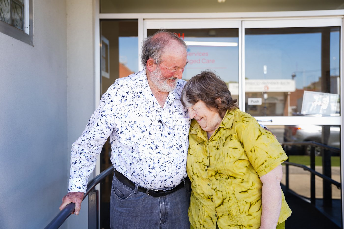 An older couple smiling and laughing.