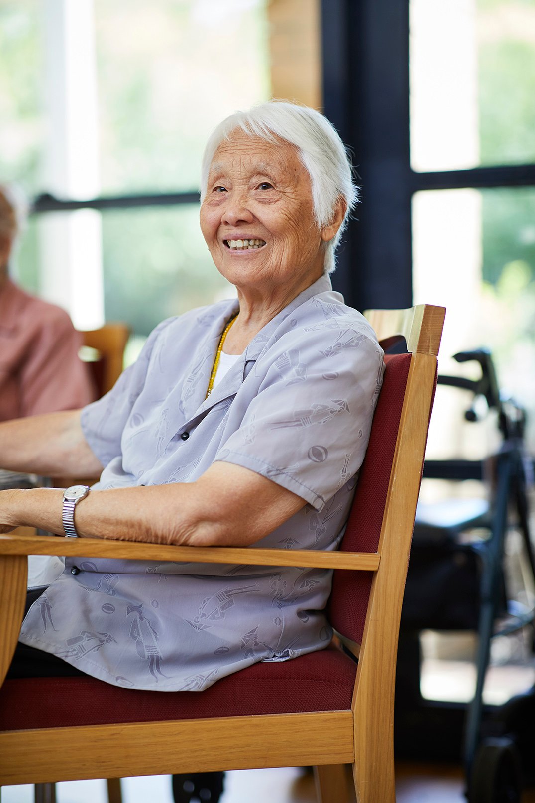 An old woman sitting at a table.