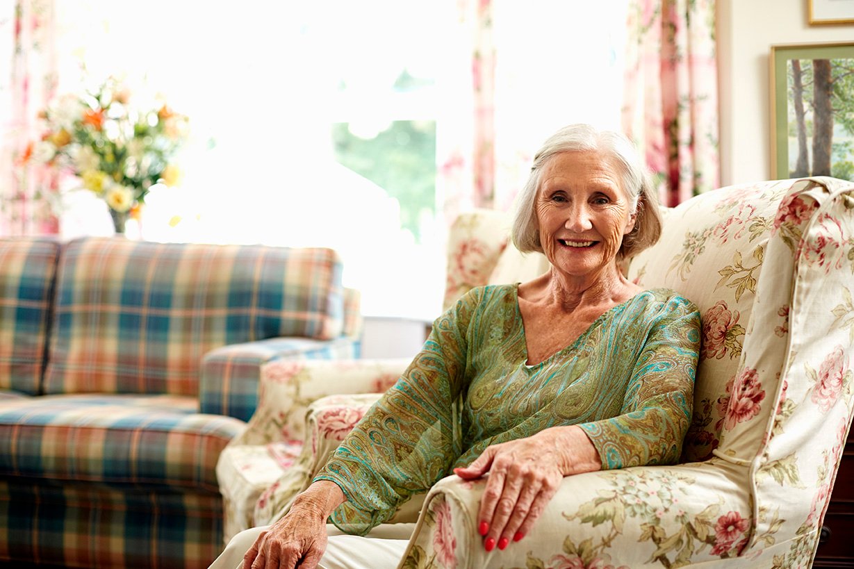 A woman with short hair sitting on a couch.