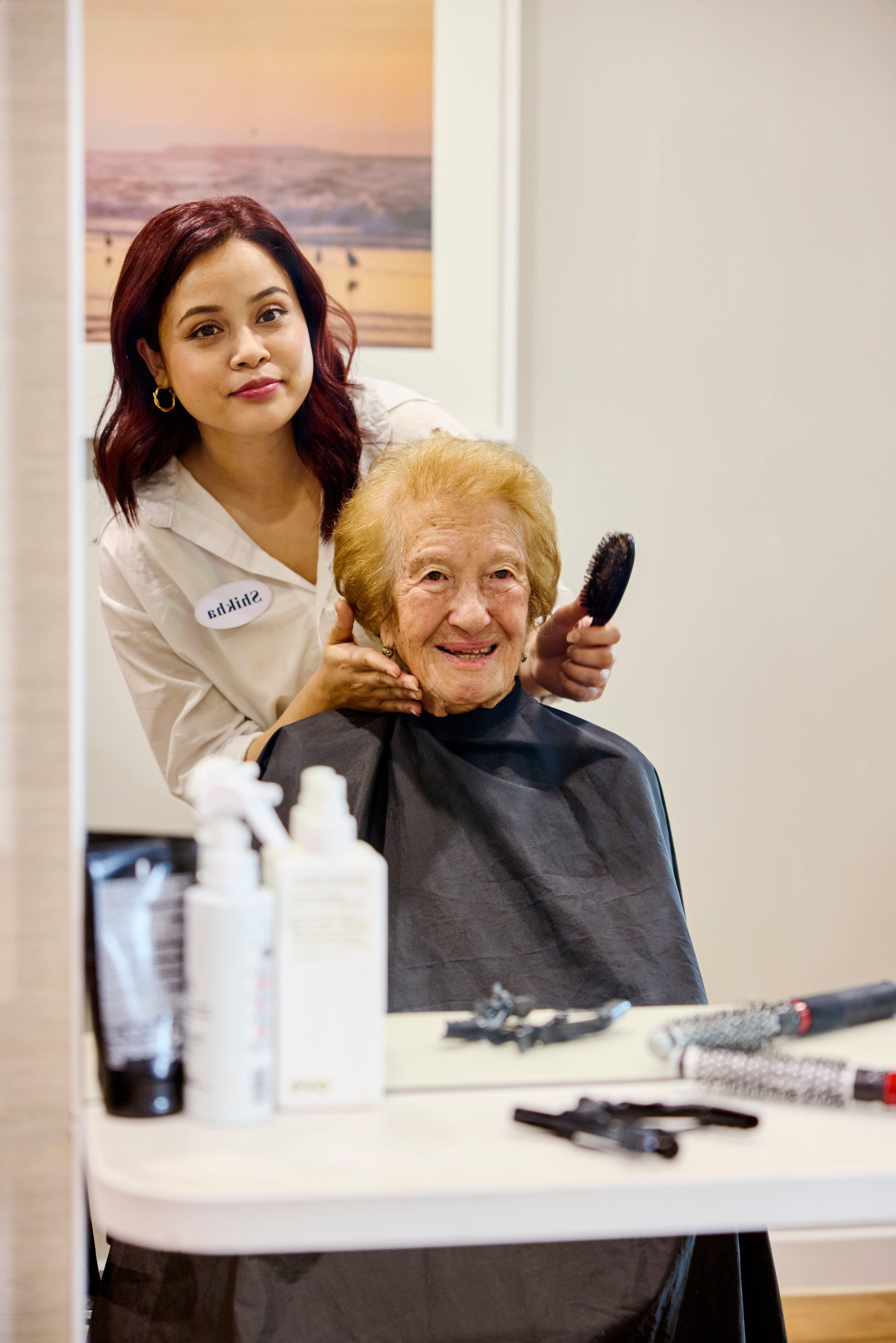 An older lady having her hair done at the hairdressers.