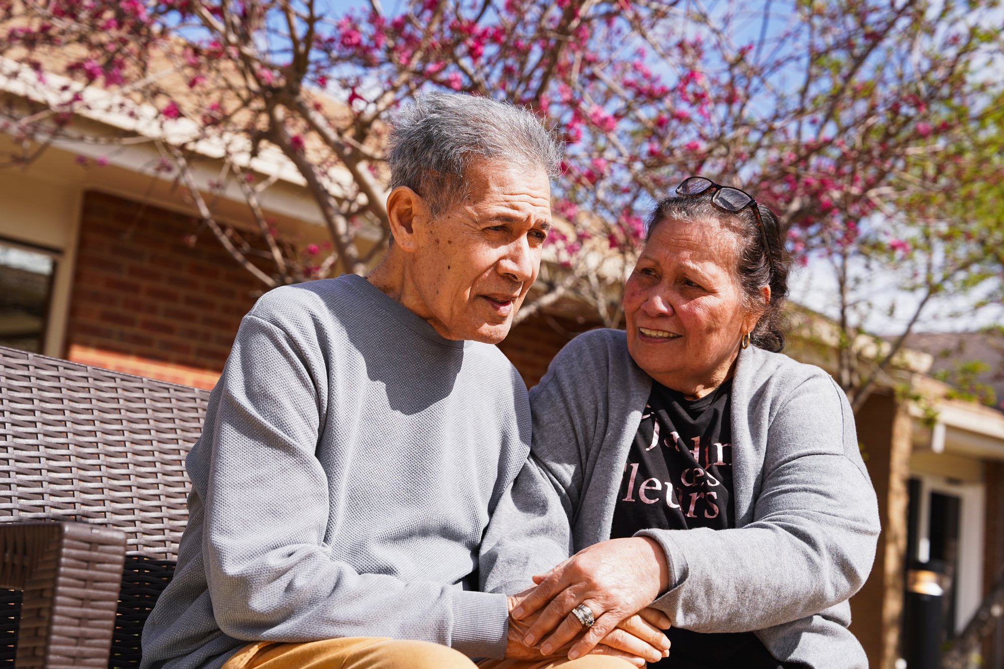 A man and woman sitting next to each other.