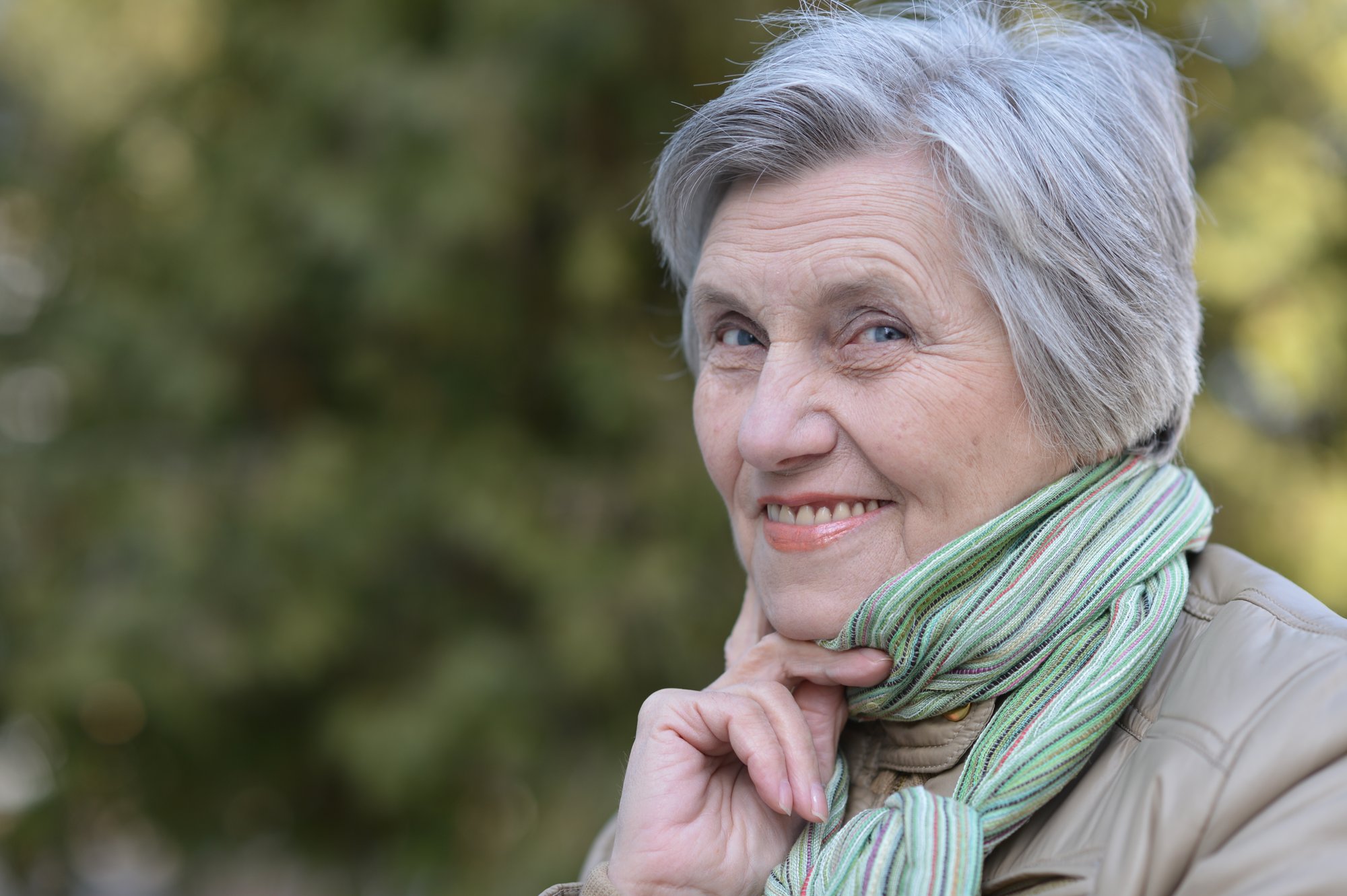Elderly woman wearing a scarf.