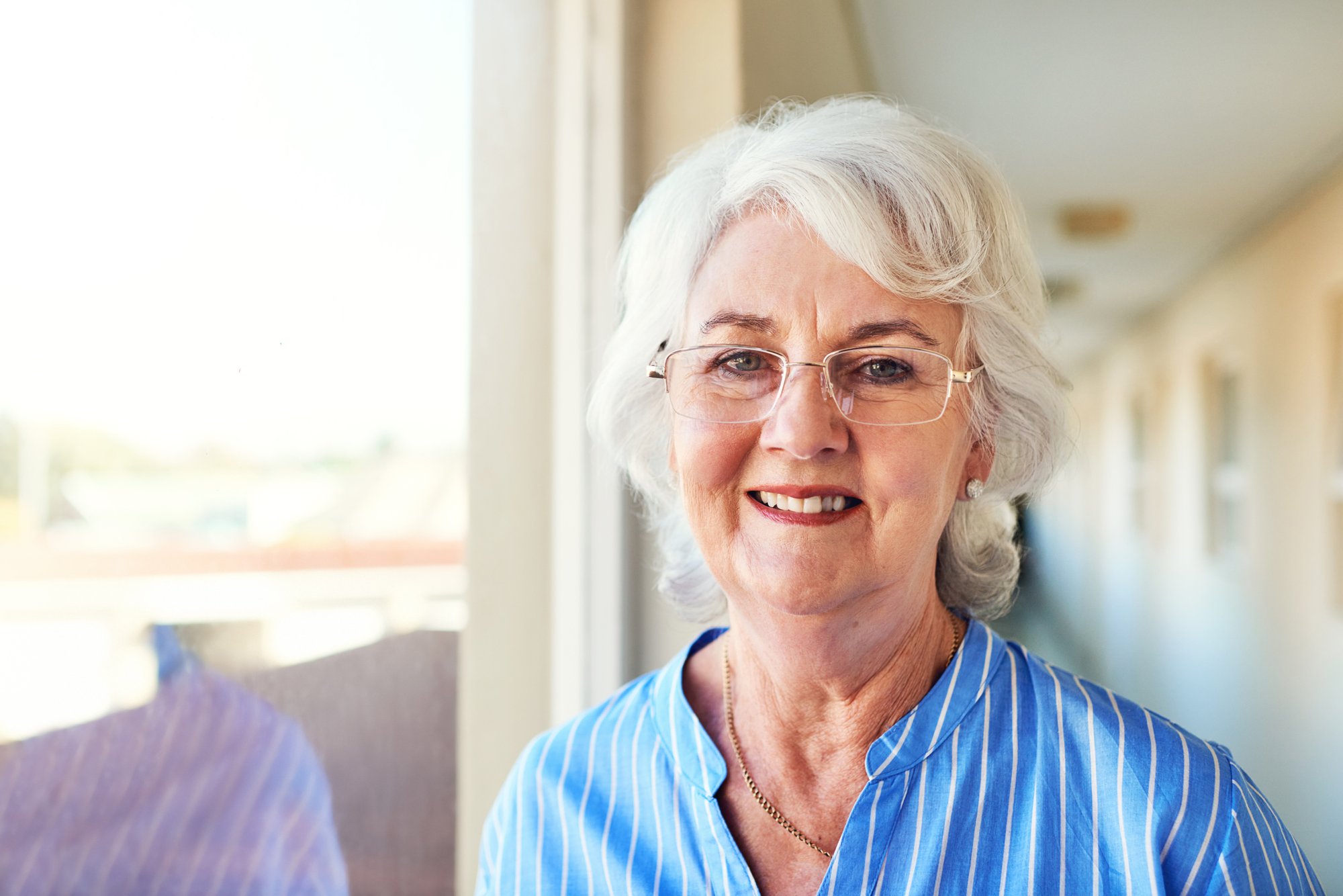 Elderly woman wearing a blue shirt.